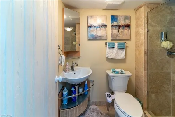 a bathroom with a toilet a sink and a mirror