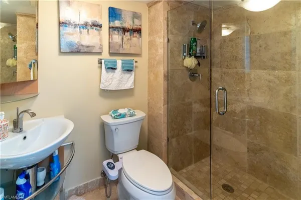 a bathroom with a toilet sink and shower