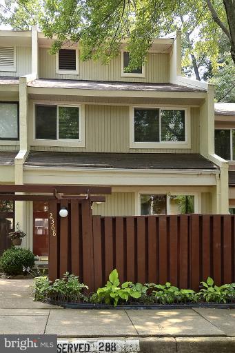 2368 Southgate Square Reston, VA 20191 - Photo 1 of 23 a front view of a house with a garden