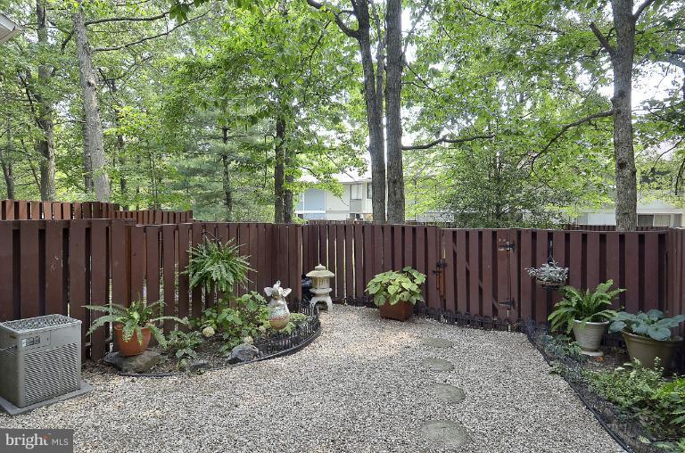 2368 Southgate Square Reston, VA 20191 - Photo 13 of 23 a garden with plants and wooden fence