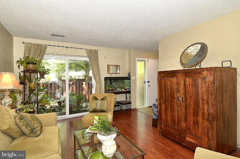 2368 Southgate Square Reston, VA 20191 - Photo 18 of 23 a living room with furniture large window and wooden floor