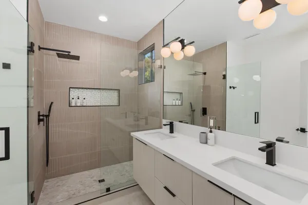 a bathroom with a sink a mirror and shower