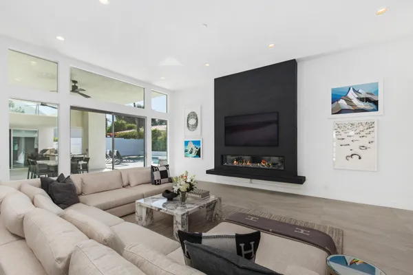 a living room with furniture and large windows