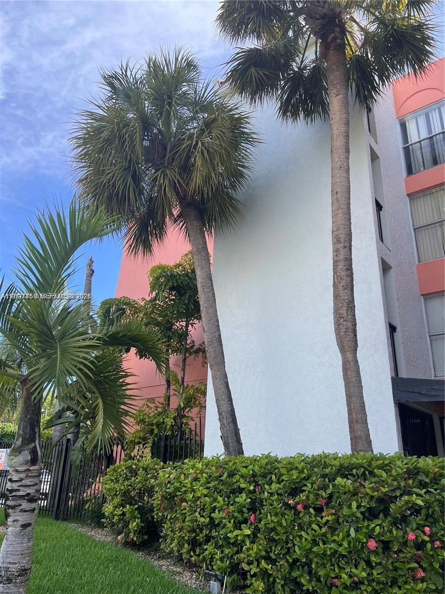 2150 Southwest 16th Avenue, Unit 406 Miami, FL 33145 - Photo 3 of 23 a view of a palm trees in front of a house