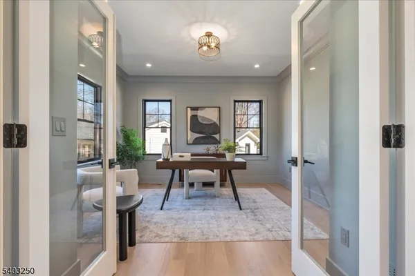 a dining room with furniture a potted plant and a chandelier