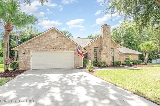 a view of a house with a yard and garage