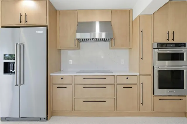 a kitchen with cabinets and a refrigerator