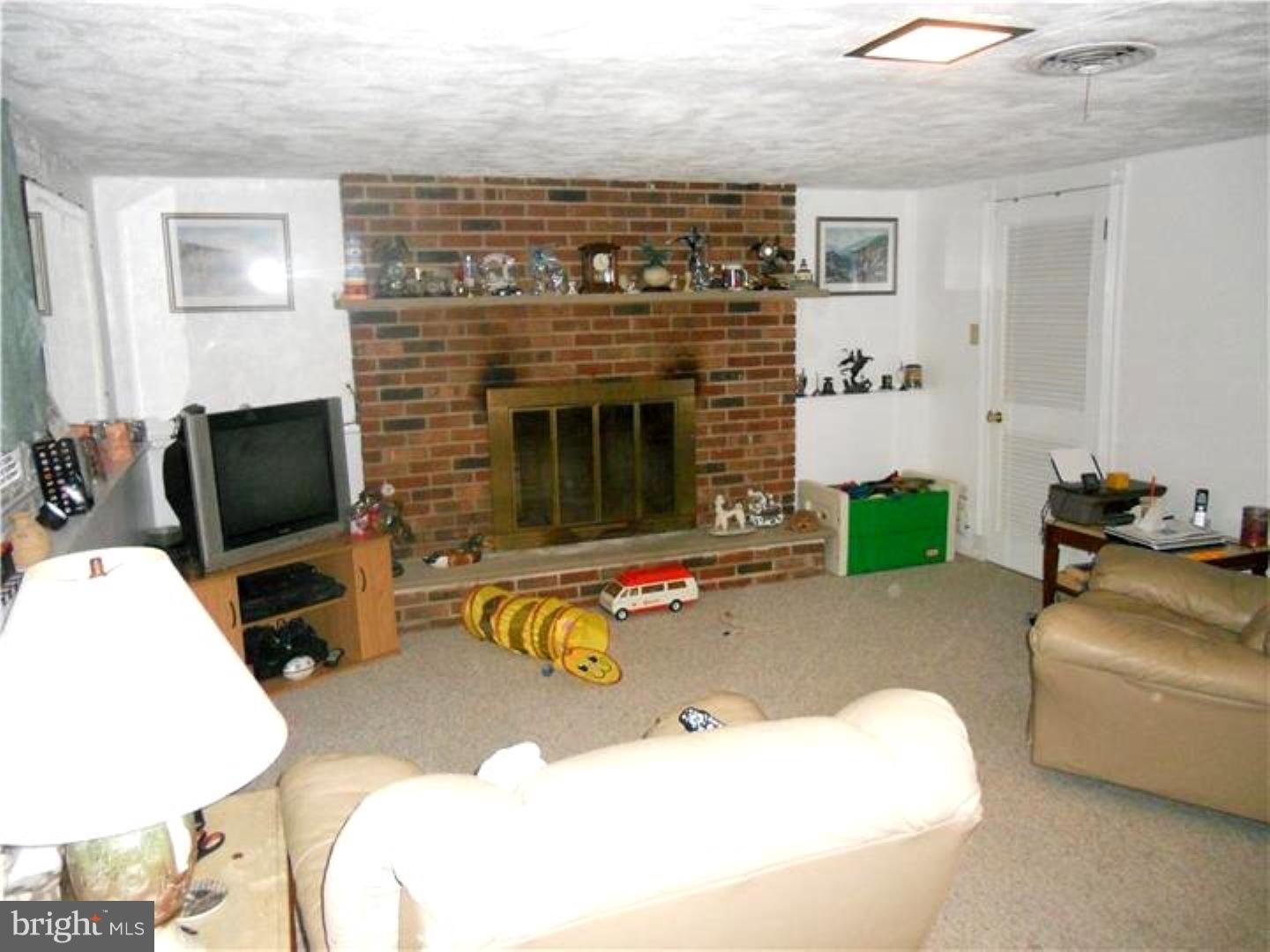 3 Radon Road Aston, PA 19014 - Photo 8 of 15 a living room with furniture and a fireplace
