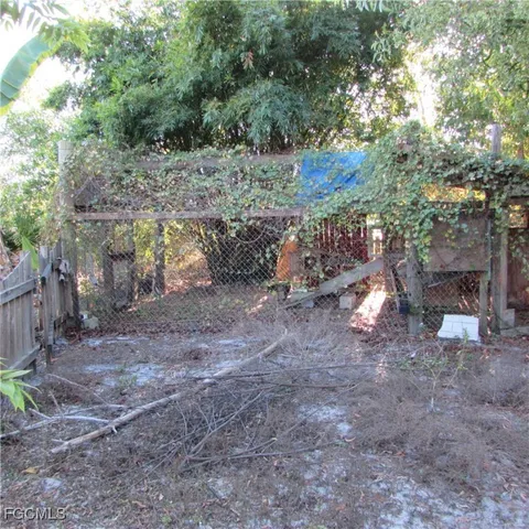 a view of a yard with plants and trees