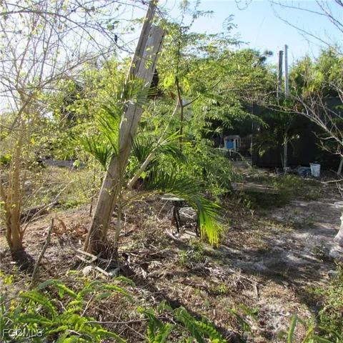 a backyard of a house with a yard and outdoor seating