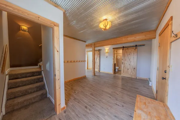 a view of a livingroom with wooden floor and a ceiling fan