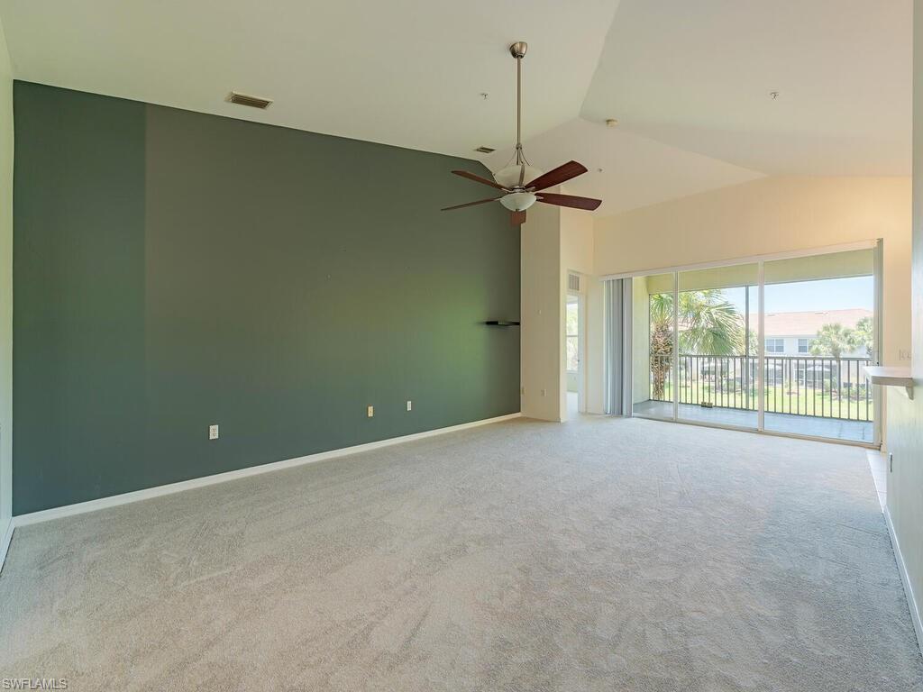 1280 Henley Street, Unit 1601 Naples, FL 34105 - Photo 3 of 15 Carpeted spare room featuring high vaulted ceiling and ceiling fan