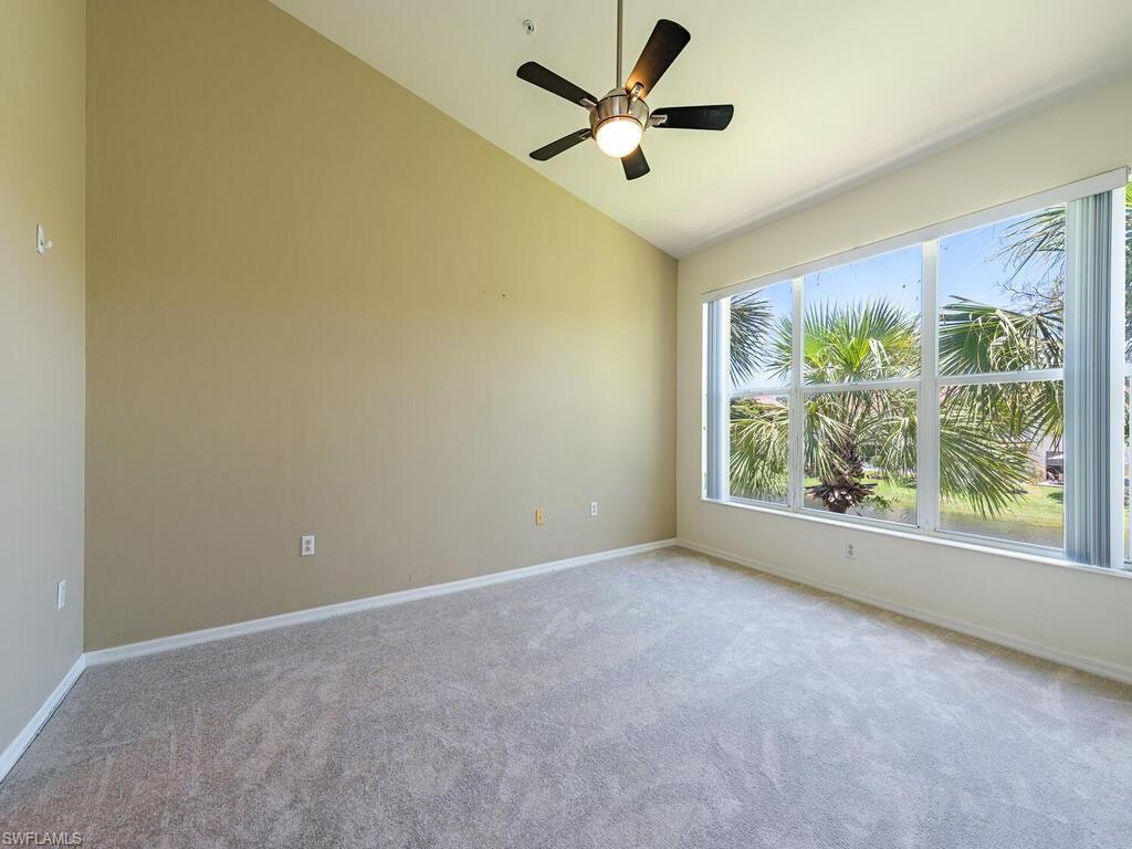 1280 Henley Street, Unit 1601 Naples, FL 34105 - Photo 7 of 15 Spare room with carpet, lofted ceiling, and ceiling fan