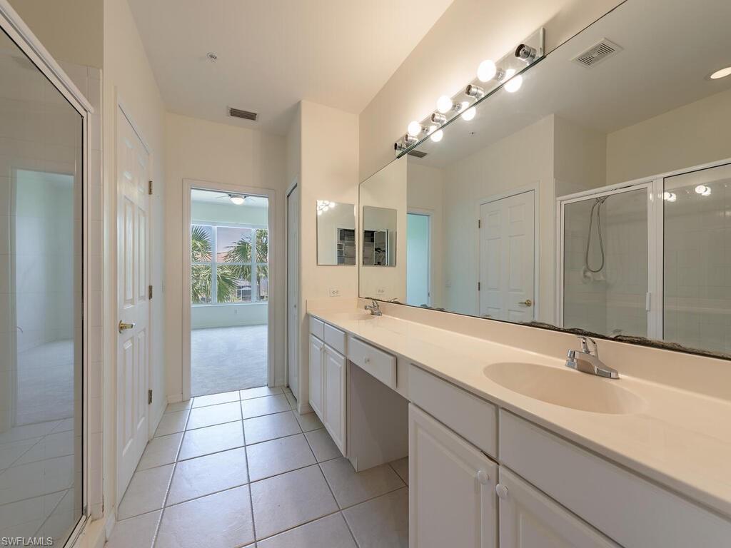 1280 Henley Street, Unit 1601 Naples, FL 34105 - Photo 8 of 15 Bathroom featuring a shower with shower door, tile patterned floors, and double sink vanity