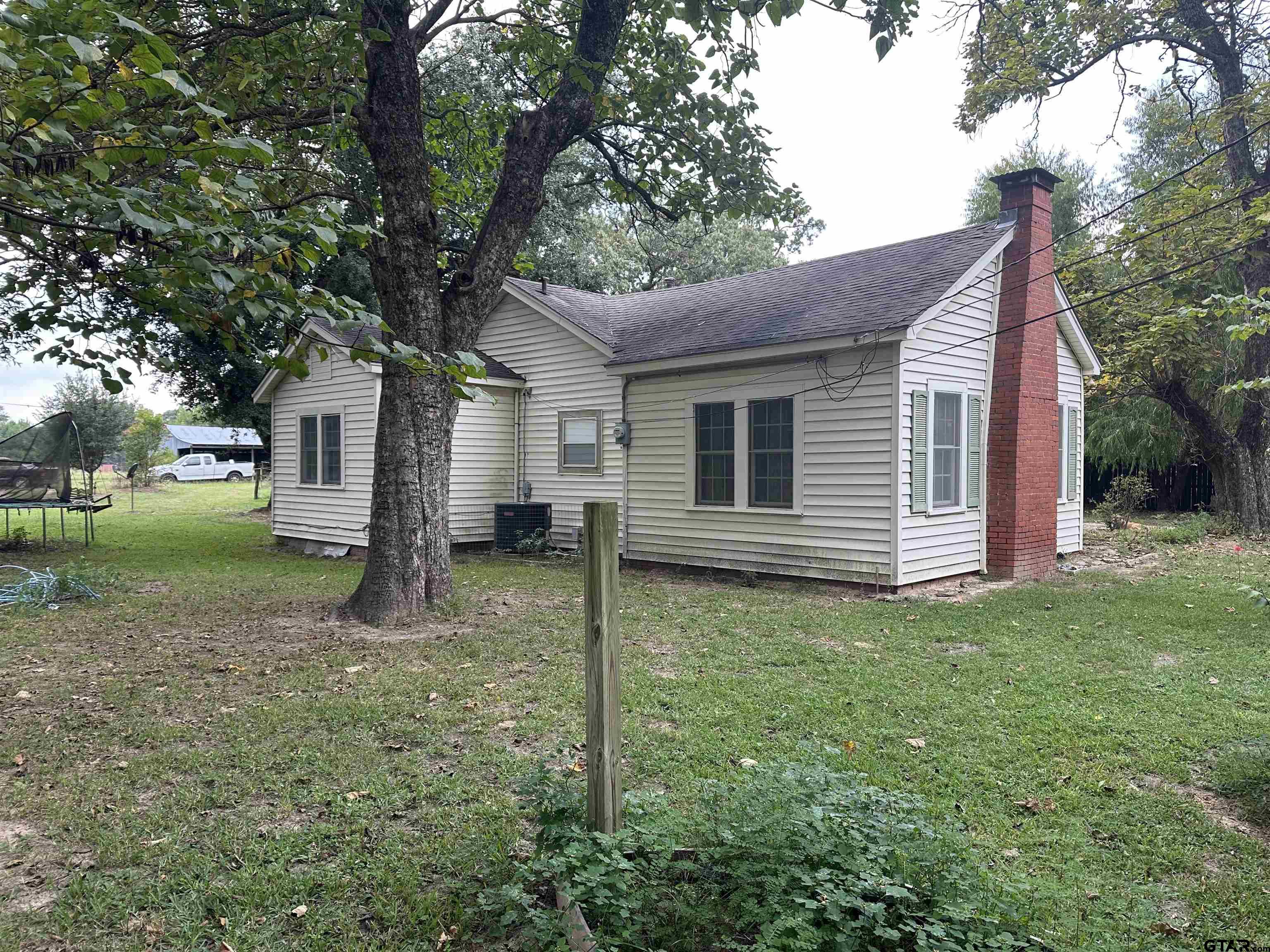 a backyard of a house with lots of green space