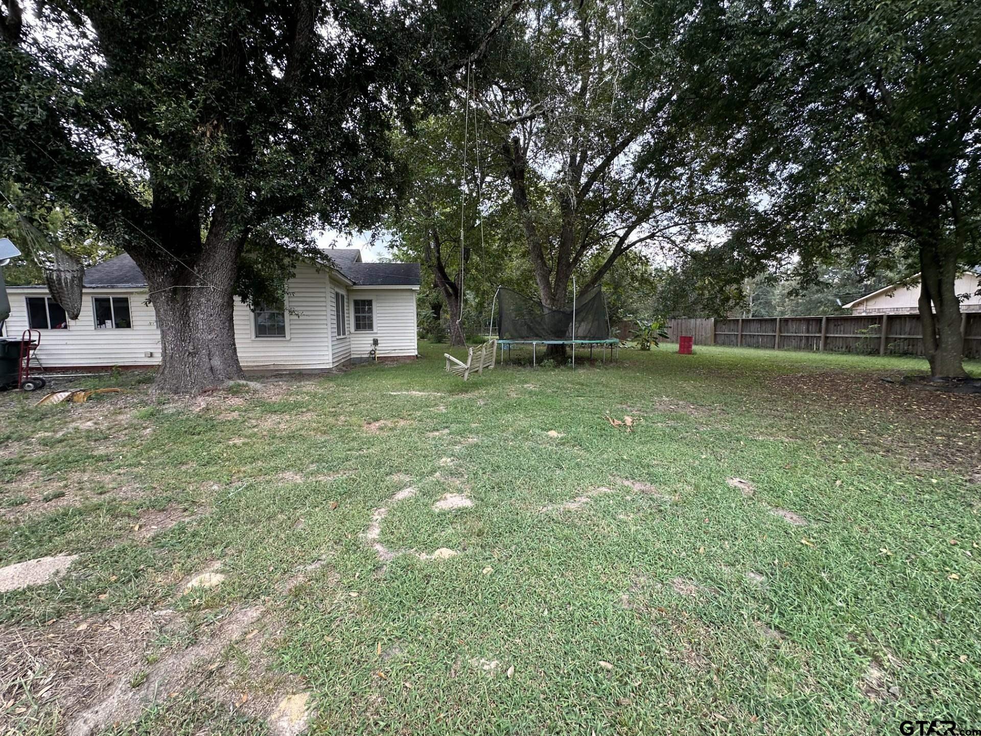 6287 County Road 334 Tyler, TX 75708 - Photo 2 of 8 a tall tree in middle of the green field