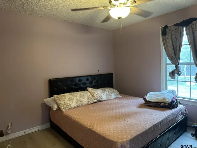 a bedroom with a bed and window