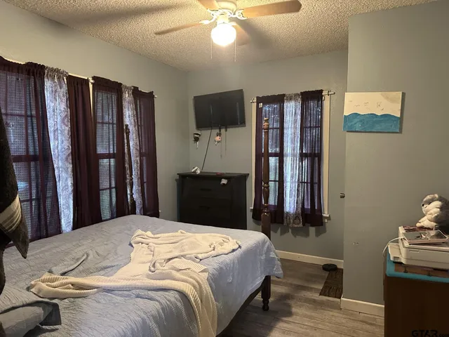 a bedroom with a bed and wooden floor