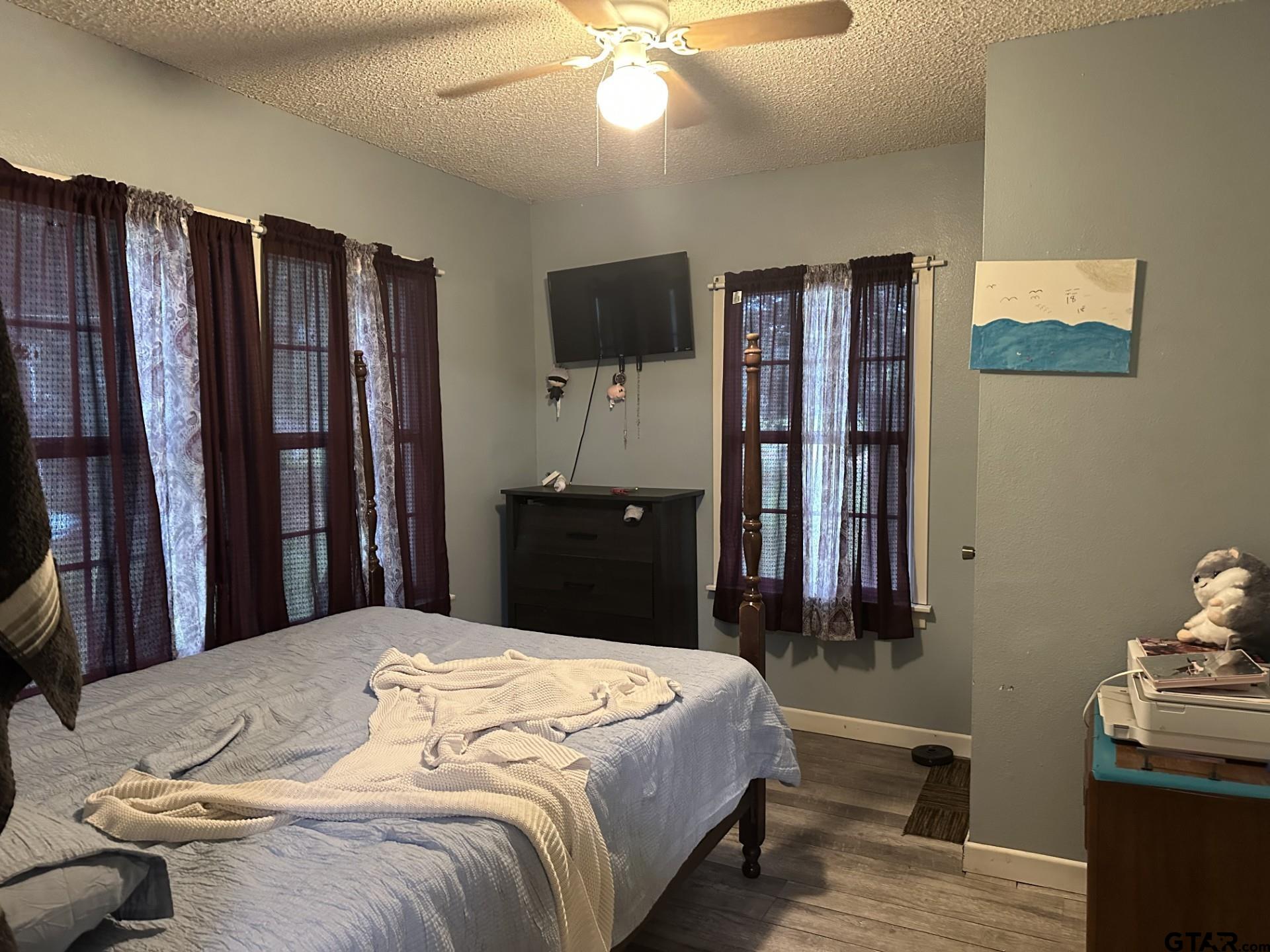 6287 County Road 334 Tyler, TX 75708 - Photo 5 of 8 a bedroom with a bed and wooden floor