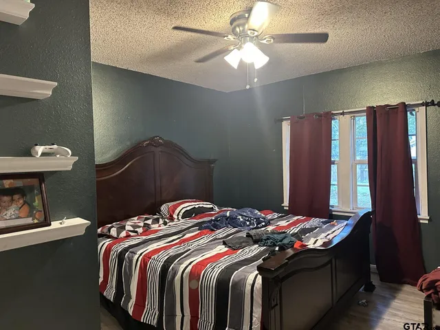 a bedroom with a bed and a chandelier