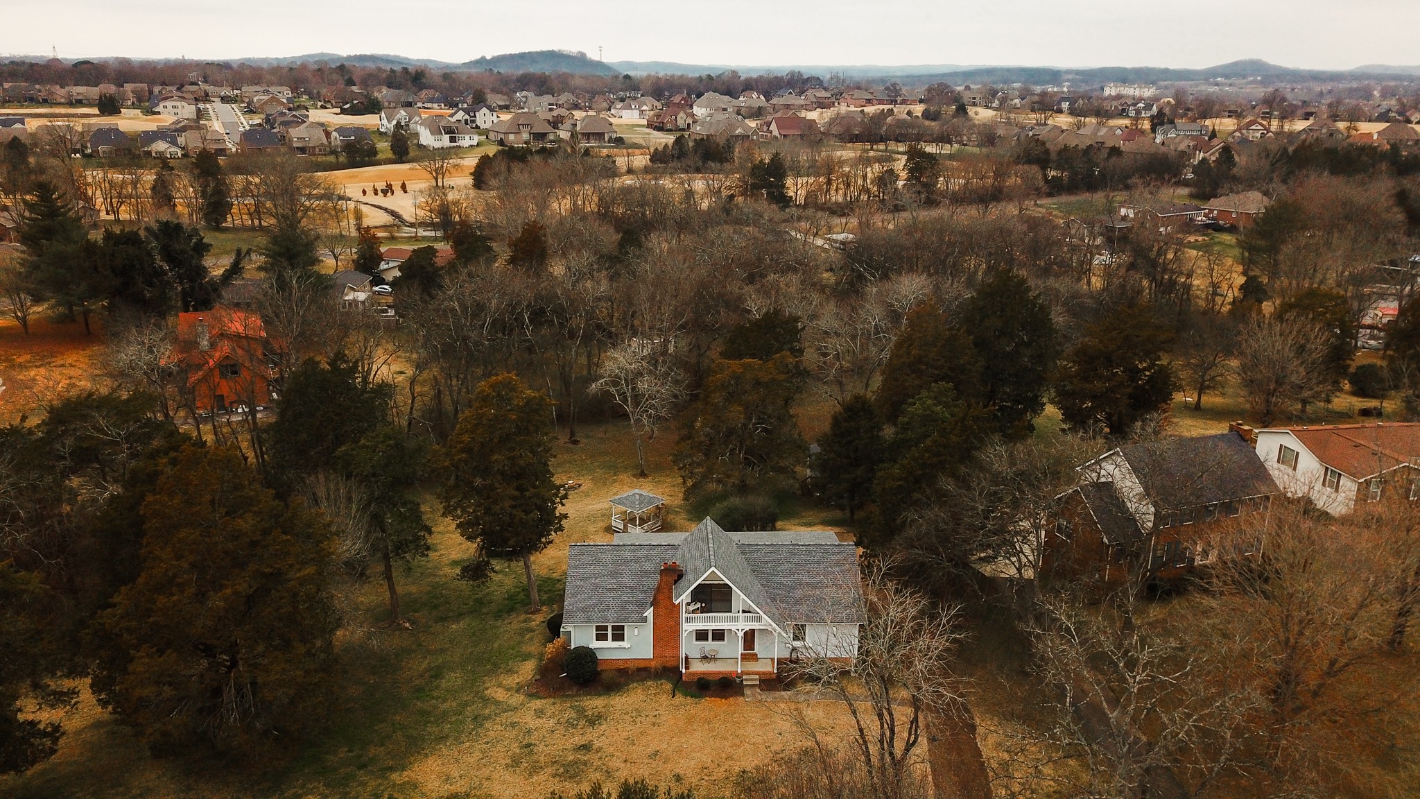 an aerial view of a house with a yard