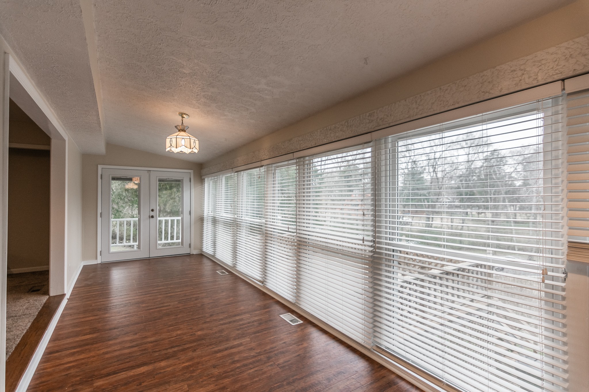 1005 Edgewater Circle Gallatin, TN 37066 - Photo 13 of 50 a view of an empty room with wooden floor and a window