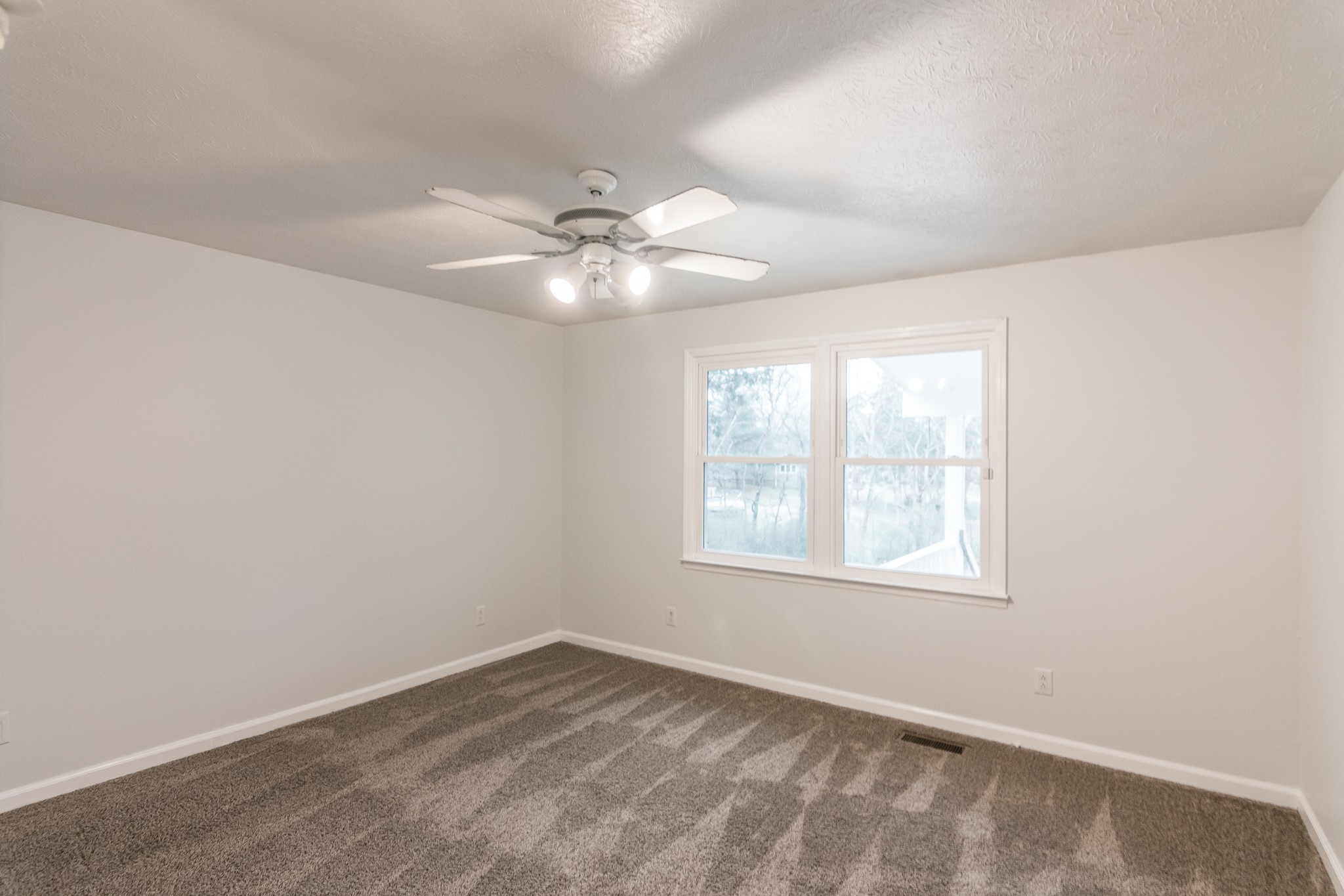 1005 Edgewater Circle Gallatin, TN 37066 - Photo 19 of 50 an empty room with a window and a fan