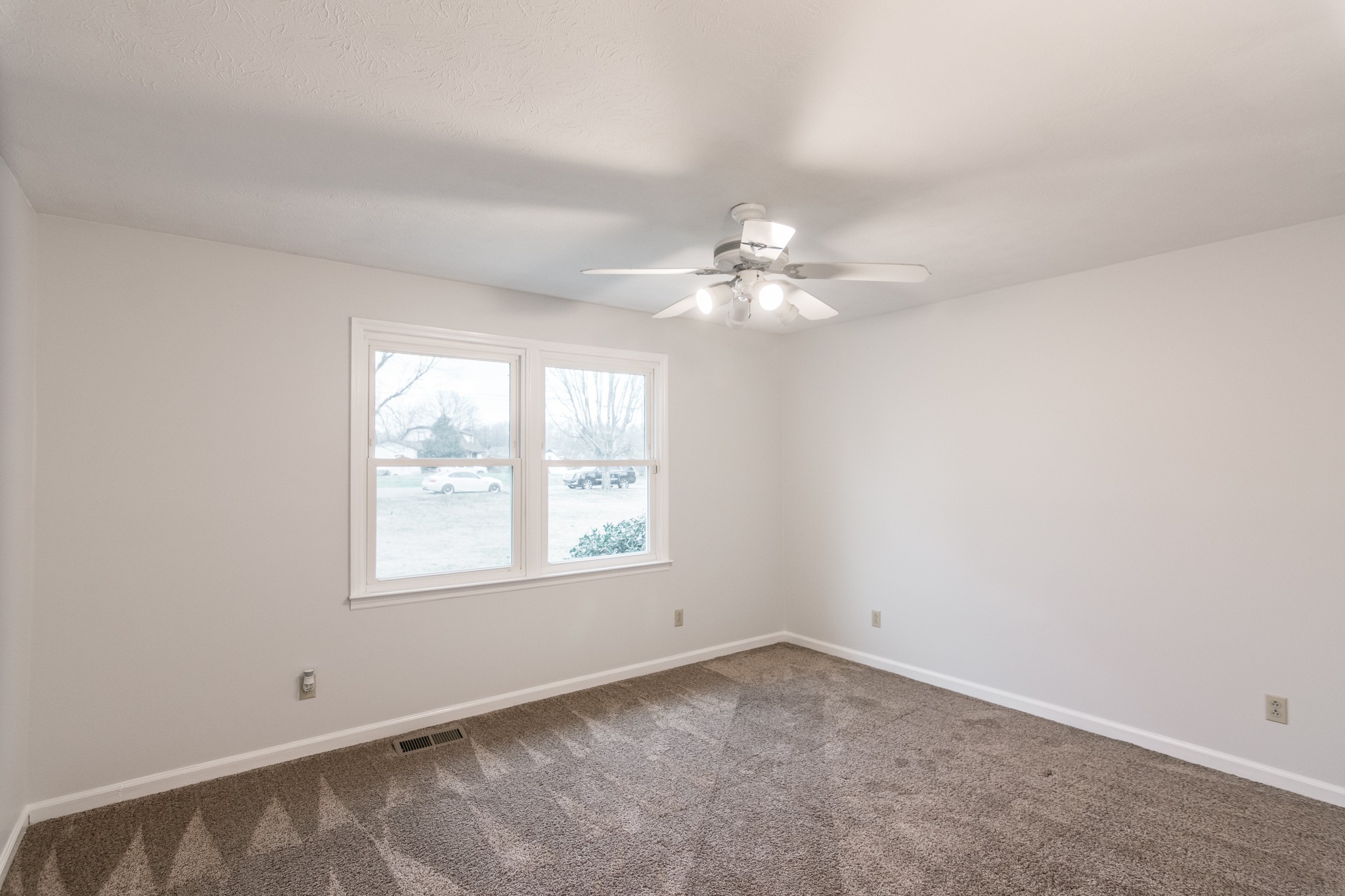 1005 Edgewater Circle Gallatin, TN 37066 - Photo 21 of 50 an empty room with a chandelier fan and windows