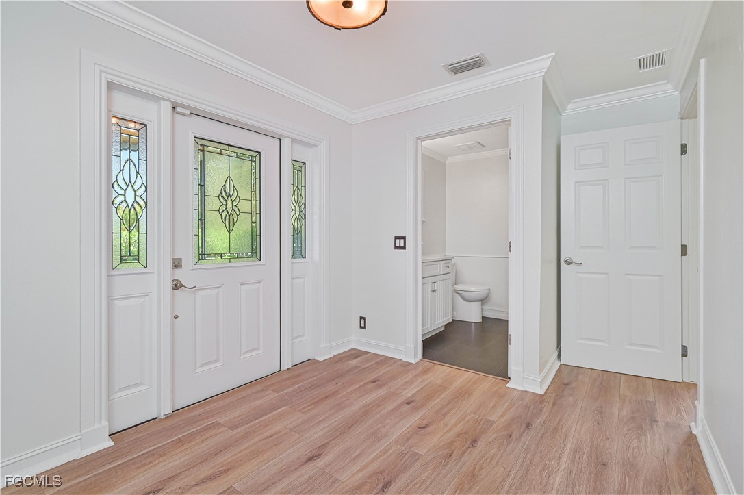 6941 Hunters Road Naples, FL 34109 - Photo 16 of 45 a view of empty room with wooden floor