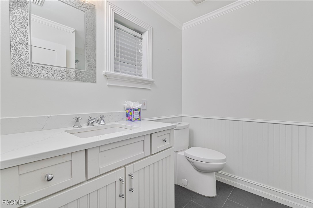 6941 Hunters Road Naples, FL 34109 - Photo 17 of 45 a bathroom with a sink and a toilet