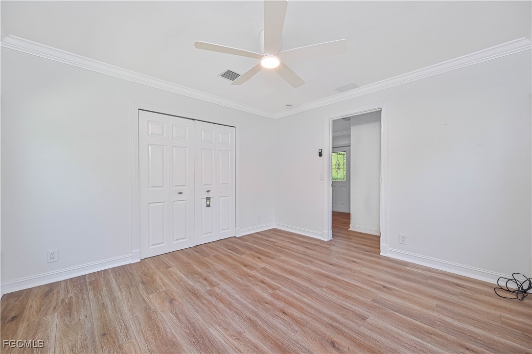 6941 Hunters Road Naples, FL 34109 - Photo 20 of 45 a view of an empty room with wooden floor