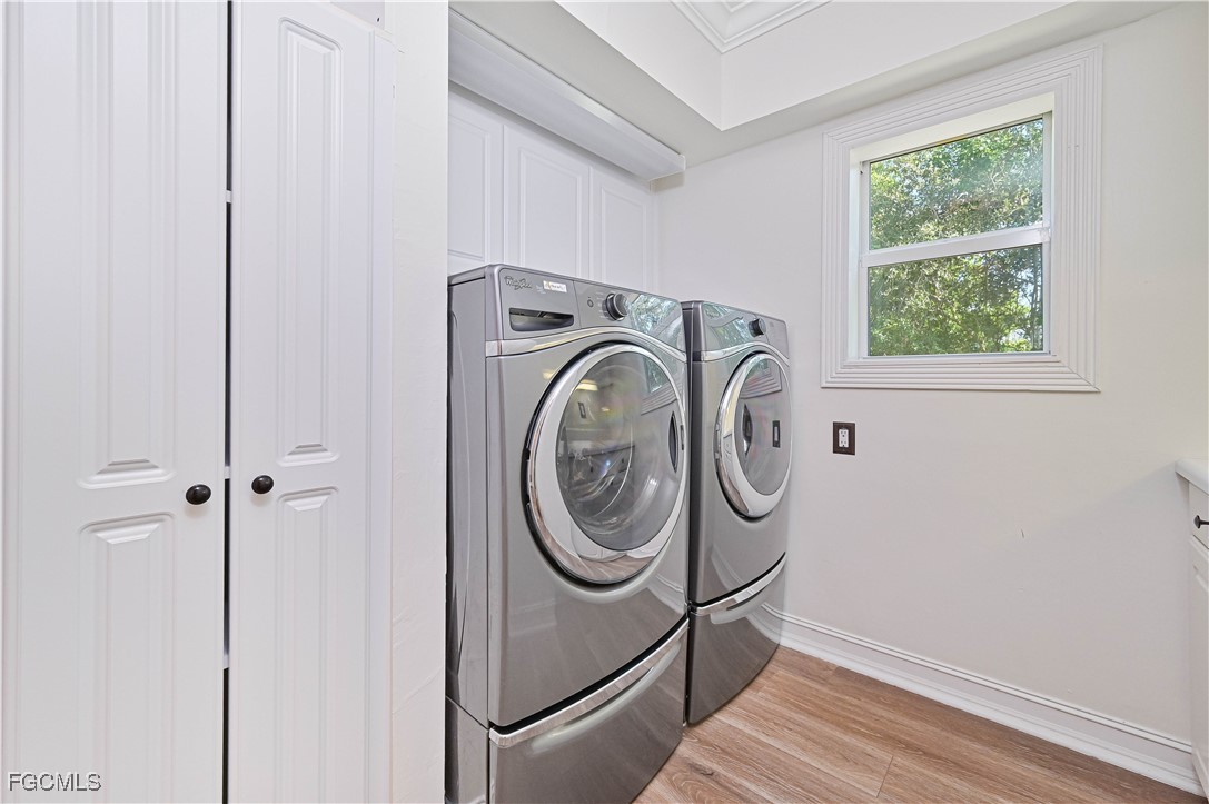6941 Hunters Road Naples, FL 34109 - Photo 21 of 45 a utility room with dryer and washer