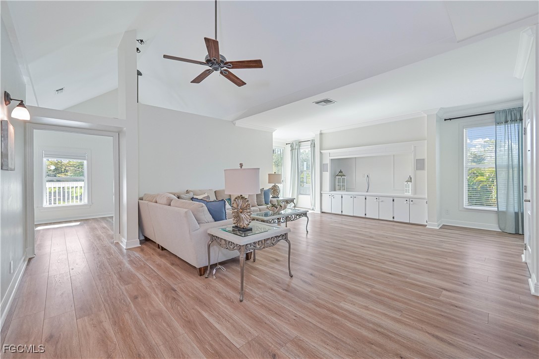 6941 Hunters Road Naples, FL 34109 - Photo 26 of 45 a living room with furniture and a wooden floor