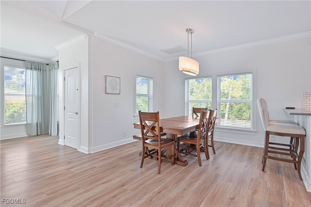 6941 Hunters Road Naples, FL 34109 - Photo 28 of 45 a view of a dining room with furniture window and wooden floor