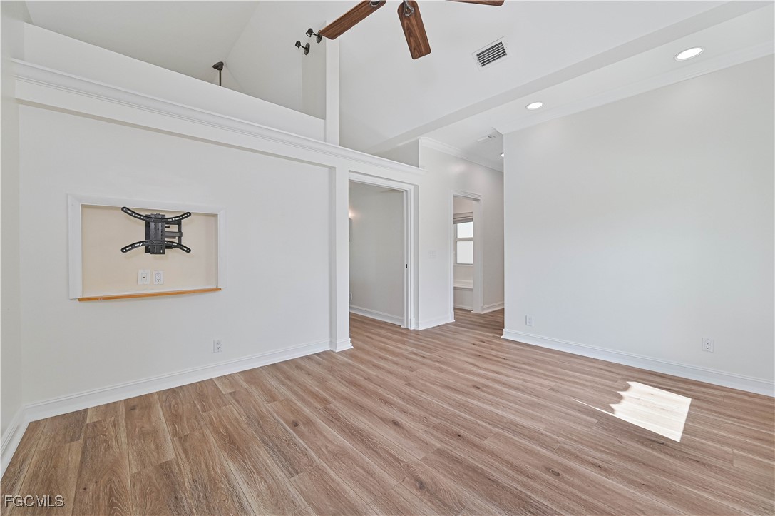 6941 Hunters Road Naples, FL 34109 - Photo 36 of 45 a view of an empty room with wooden floor