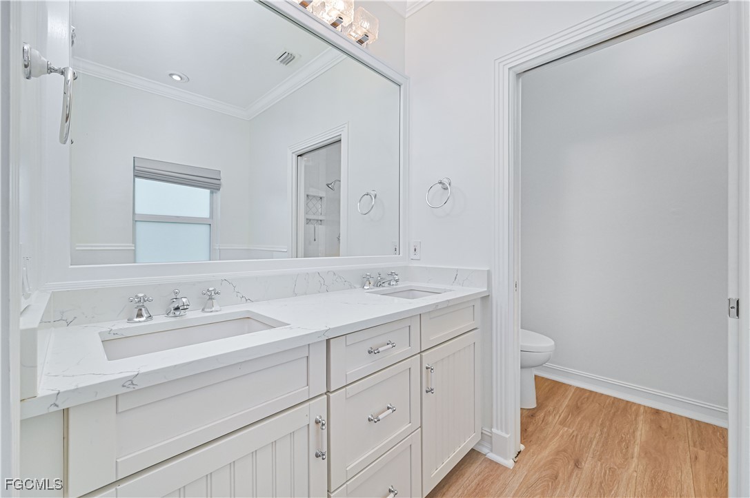 6941 Hunters Road Naples, FL 34109 - Photo 38 of 45 a bathroom with a sink and a mirror