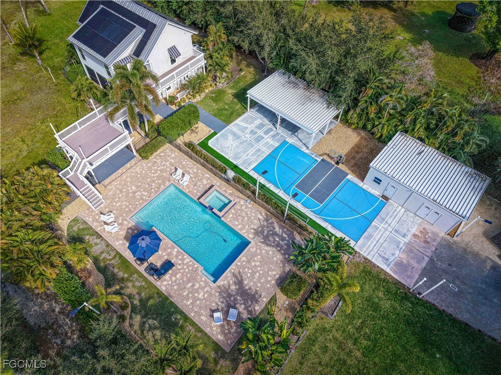 6941 Hunters Road Naples, FL 34109 - Photo 4 of 45 an aerial view of a house with a yard and outdoor seating