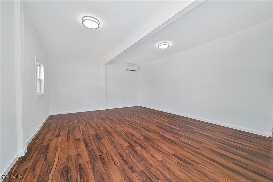 6941 Hunters Road Naples, FL 34109 - Photo 44 of 45 a view of empty room with wooden floor