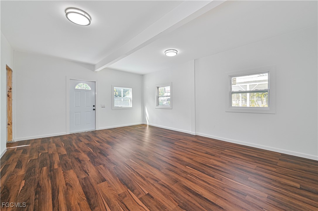 6941 Hunters Road Naples, FL 34109 - Photo 45 of 45 an empty room with wooden floor and windows