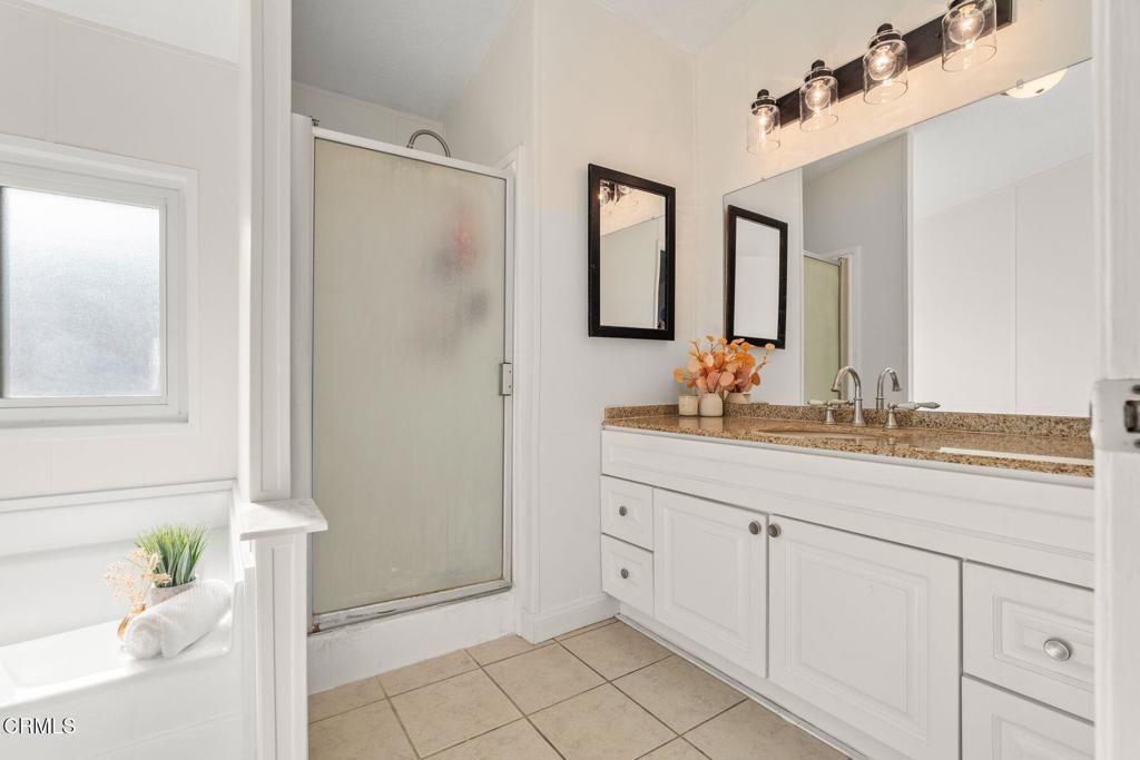1025 Cachuma Avenue, Unit 59 Ventura, CA 93004 - Photo 13 of 36 a bathroom with a double vanity sink and a mirror