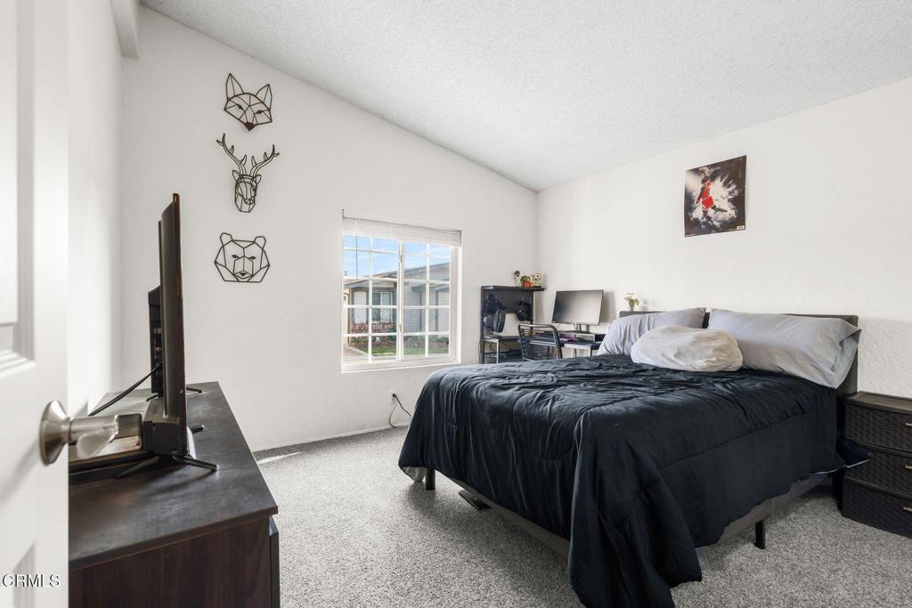 1025 Cachuma Avenue, Unit 59 Ventura, CA 93004 - Photo 14 of 36 a bedroom with a bed and a flat screen tv