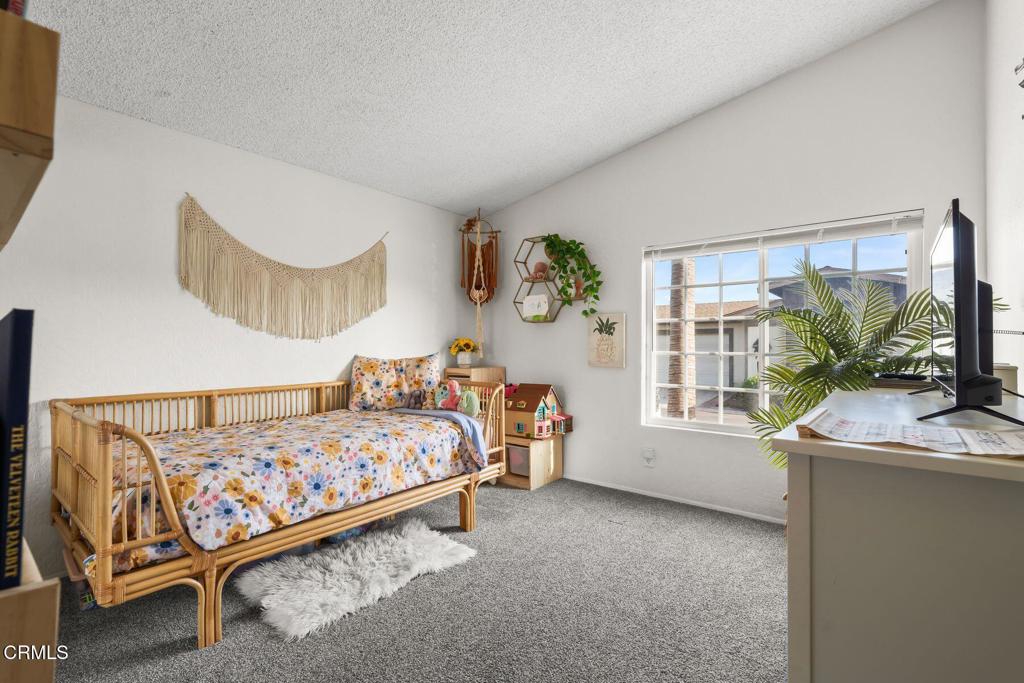 1025 Cachuma Avenue, Unit 59 Ventura, CA 93004 - Photo 15 of 36 a bedroom with a bed and a large window