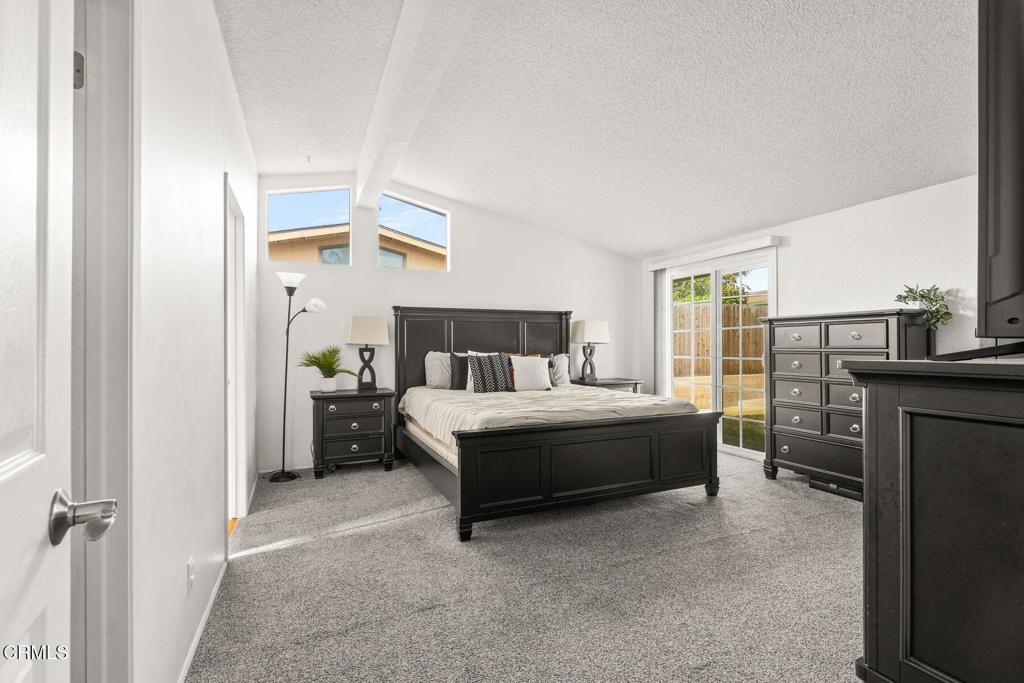 1025 Cachuma Avenue, Unit 59 Ventura, CA 93004 - Photo 10 of 36 a spacious bedroom with a bed and a flat tv screen on dresser