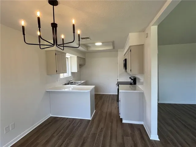 a very nice looking room with wooden floor and a sink