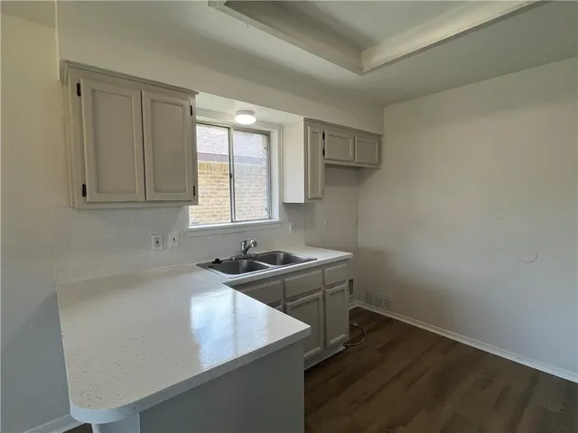 a kitchen with a sink stove and cabinets