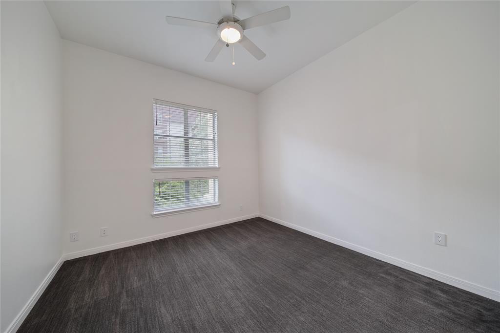 3225 Turtle Creek Boulevard, Unit 320 Dallas, TX 75219 - Photo 13 of 24 an empty room with wooden floor and windows