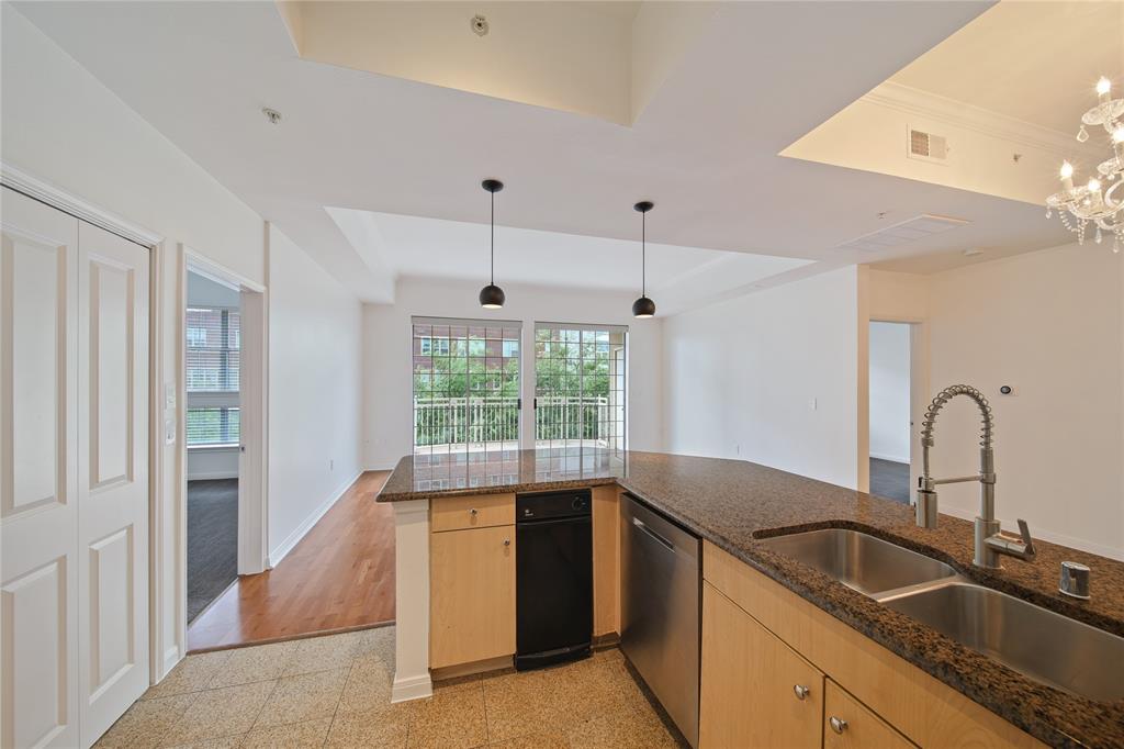 3225 Turtle Creek Boulevard, Unit 320 Dallas, TX 75219 - Photo 2 of 24 a kitchen with a sink and a large window