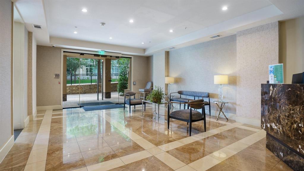 3225 Turtle Creek Boulevard, Unit 320 Dallas, TX 75219 - Photo 23 of 24 a living room with furniture and a large window