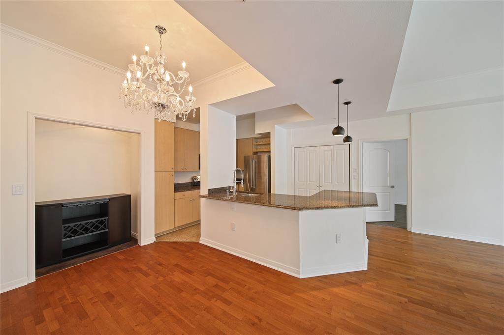 3225 Turtle Creek Boulevard, Unit 320 Dallas, TX 75219 - Photo 5 of 24 a living room with stainless steel appliances kitchen island granite countertop furniture and a kitchen view