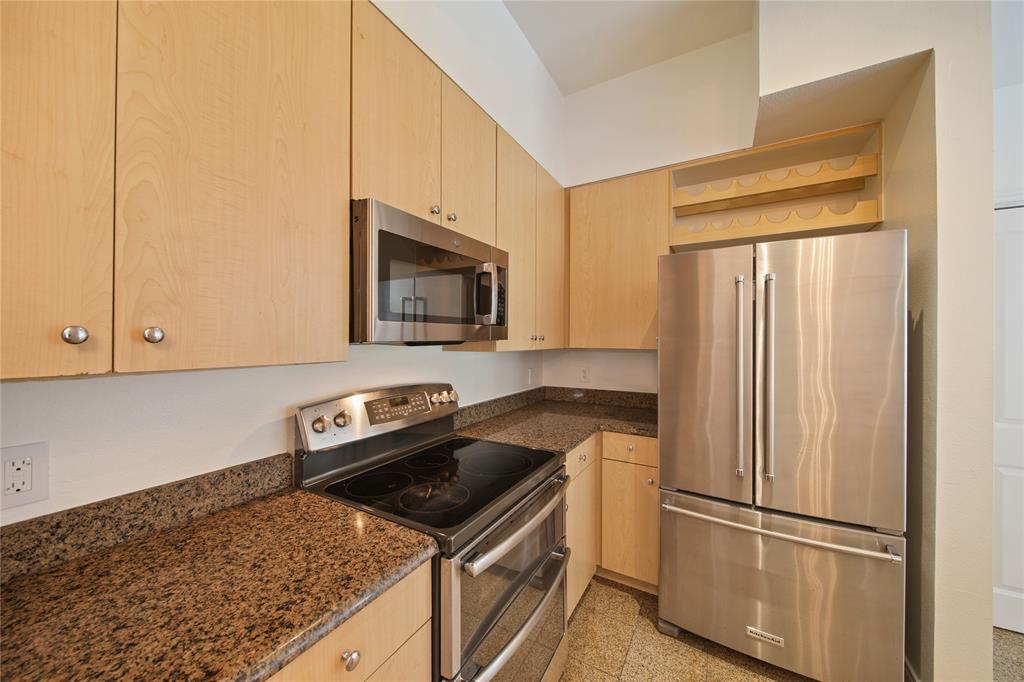 3225 Turtle Creek Boulevard, Unit 320 Dallas, TX 75219 - Photo 7 of 24 a kitchen with a refrigerator stove and microwave
